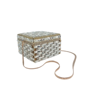 Detail of crystal clutch bag with rectangular rhinestones and rose gold chain strap