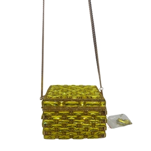 Detail of lime green crystal evening clutch with metallic chain and spare rhinestones