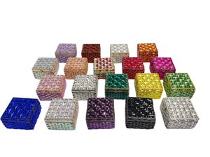 Macro view of crystal encrusted square evening bags and jewelry boxes in various colors