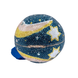 Macro shot of spherical evening clutch featuring moon and star rhinestone patterns