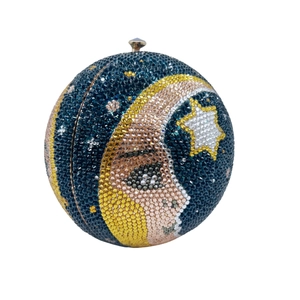 Macro detail of sphere clutch bag with moon and stars rhinestone mosaic design