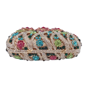 Detailed close-up of crystal-encrusted luxury floral evening clutch bag with colorful gems