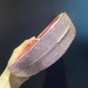 Luxury round evening clutch bag with sparkling pink crystals and golden metal hardware