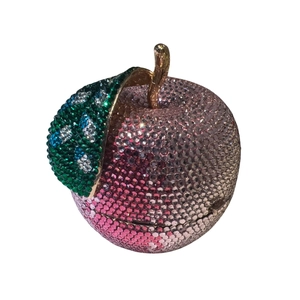 Detailed view of apple-shaped luxury clutch with pink gradient rhinestones and gold handle