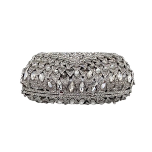 Macro shot of silver rhinestone hollow-out evening clutch with leaf petal crystal texture