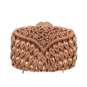 Close-up of champagne gold evening bag with marquise rhinestones and metal snap