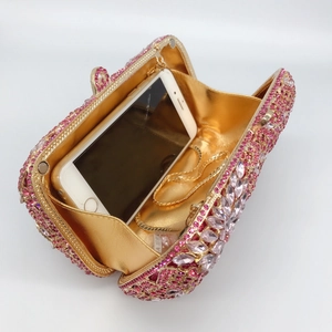 Detail of gradient rhinestone clutch bag interior showing space for a smartphone