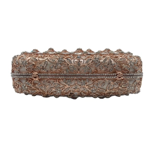 Detailed view of rose gold hollow-out crystal clutch bag with intricate metal mesh and rhinestones