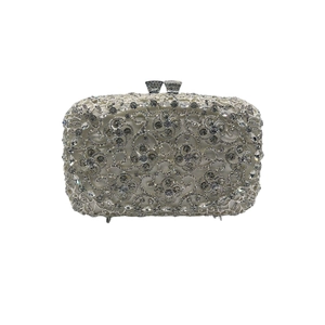 Detailed view of hollow-out silver evening clutch with sparkling crystal inlays