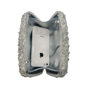 Top view of open silver crystal clutch showing interior space and detachable metal chain