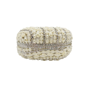 Detailed view of an oval evening clutch with pearls and crystal rhinestones