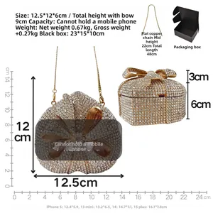 Detail showing crystal-encrusted heart clutch with bow detail and chain in a gift box