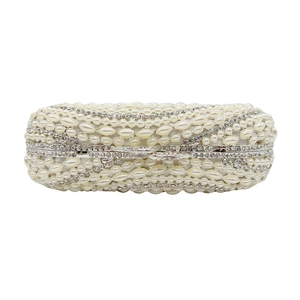 Detailed view of luxury evening clutch featuring white pearls and shimmering crystal rhinestones