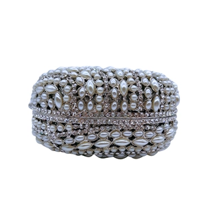 Close-up of luxury clutch featuring leaf-shaped crystal pattern and dense pearl beads