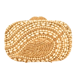 Close-up of elegant leaf-patterned clutch with intricate pearls and crystal rhinestones