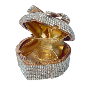 Luxury heart-shaped clutch bag with white rhinestones and a crystal bow accent