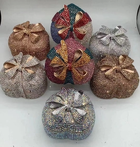 Macro detail of heart-shaped evening clutch bags with crystal rhinestones and bow clasp