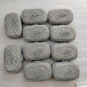 Silver crystal evening clutch bag with feather-patterned pearl embroidery and metal snap