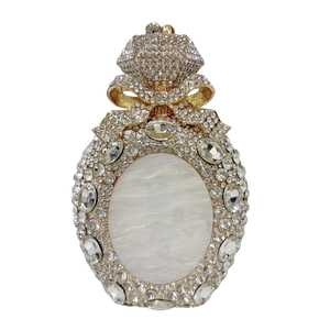 Detailed view of luxury perfume bottle evening bag with crystals and bow detail