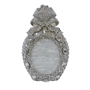 Detail of crystal-encrusted evening clutch with marble inlay and crown clasp