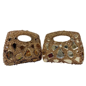 Detailed view of luxury evening handbags featuring champagne crystals and golden rhinestones