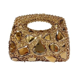 Detail of luxury evening handbag featuring gold crystal rhinestones and geometric jewels