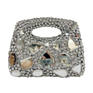 Macro shot of silver evening bag with sparkling rhinestones and mixed geometric crystals