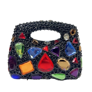 Detail of evening bag with colorful crystals and sparkling black rhinestones on fabric