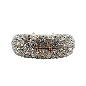 Macro shot of oval rhinestone clutch bag with rose gold frame and sparkling crystals