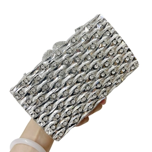 Luxury silver evening clutch bag with wave-patterned crystals and heart clasp