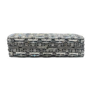 Detailed view of silver evening clutch bag with sparkling encrusted crystals and metal frame