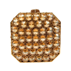 Detailed macro view of champagne gold evening clutch with large faceted crystal rhinestones