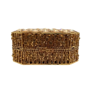 Detailed view of the octagonal golden crystal clutch bag with champagne rhinestones