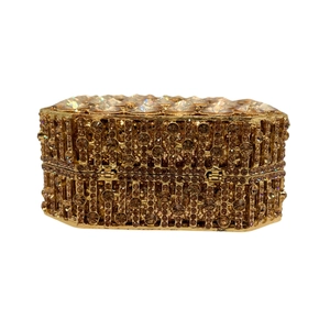 Detailed close-up of champagne gold rhinestone evening clutch with crystal-encrusted lid