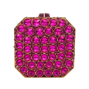 Detailed close-up of pink rhinestone clutch bag with crystal facets and gold clasp