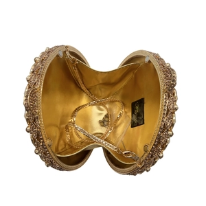 Top view of open champagne gold rhinestone evening bag with chain and satin lining