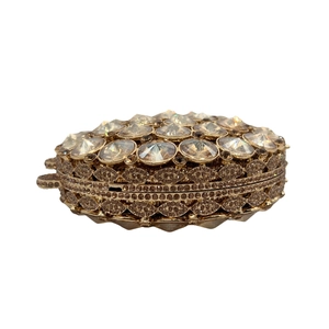 Detail view of the champagne diamond-encrusted evening bag with large faceted crystals