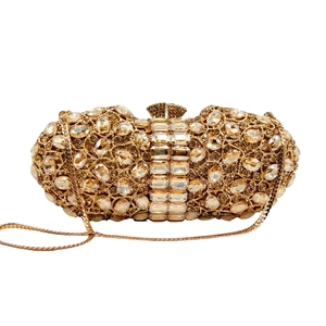 Macro detail of luxury evening clutch with sparkling rhinestones and gold chain strap