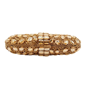 Close-up of golden oval clutch bag with amber rhinestones and rectangular crystal details