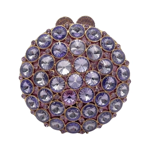 Close-up of luxury round evening bag featuring purple rhinestones and gold metal clasp