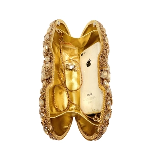 Internal view of gold rhinestone clutch bag showing storage space for a smartphone