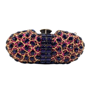 Detailed macro of a purple crystal encrusted evening clutch with gold metal frame