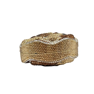 Detailed macro shot of wavy crystal rhinestone patterns on the round evening clutch bag