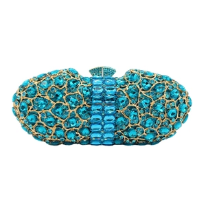 Close-up of sparkling blue rhinestones and gem-shaped clasp on a luxury clutch bag