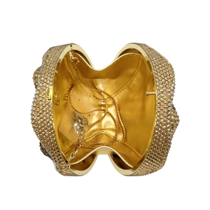 Top view of gold rhinestone evening clutch showing metallic frame and inner chain strap