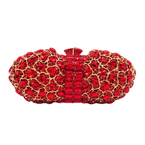 Macro detail of red rhinestone crystal clutch bag with gold-tone metal frame