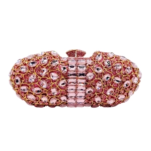 Detailed view of luxury pink crystal evening clutch bag with gold metal frame