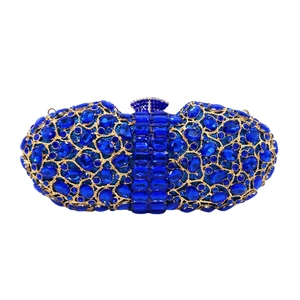 Close-up of royal blue crystals and gold openwork metal on the luxury clutch bag