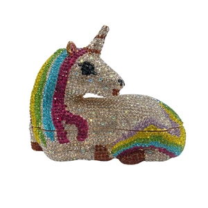 Close-up of rainbow rhinestones and gold metal trim on the unicorn clutch bag