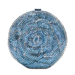 Macro detail of blue and silver rhinestone encrusted rose petals on round clutch bag